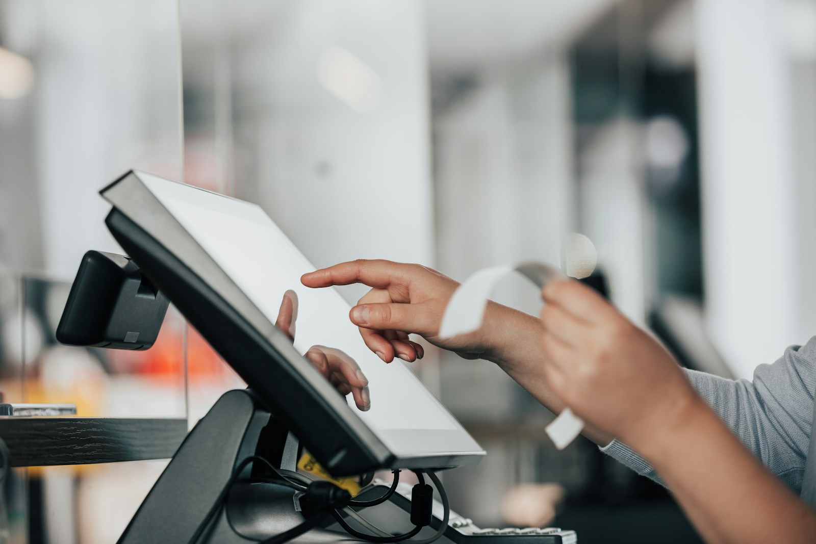 Cashier using a touchscreen point-of-sale system